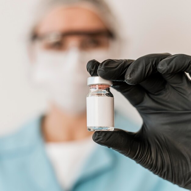 Defocused female doctor with vaccine