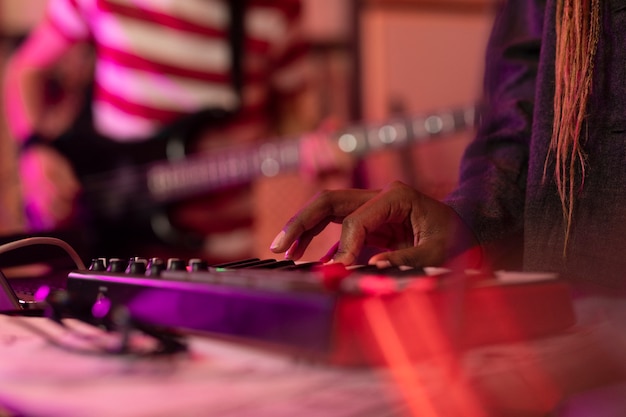 Defocused keyboard player at a local music event