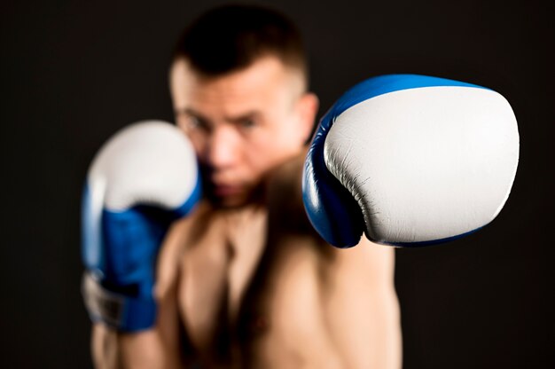 Defocused male boxer with protective gloves