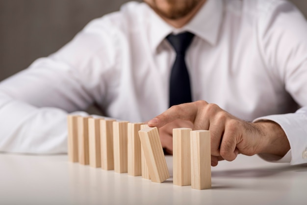 Defocused man in shirt and tie with dominoes