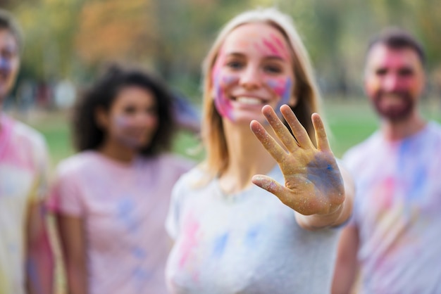 Free Photo defocused shot of woman showing multicolored hand