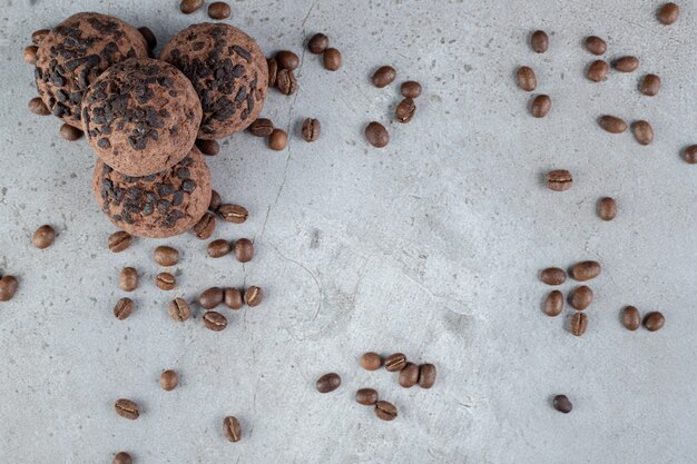 Delectable cookies with chocolate chip topping and scattered coffee beans on marble surface