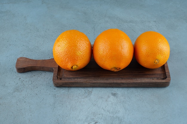 Delectable oranges on a board , on the marble background. High quality photo