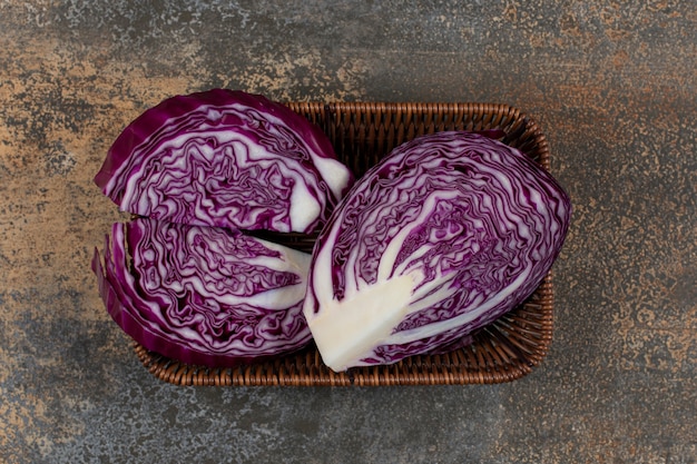 Delectable red cabbage in the wicker basket on the marble surface