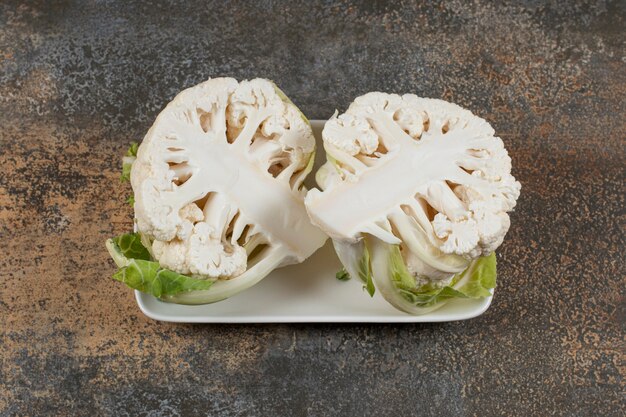 Delectable sliced cauliflower in the bowl , on the marble surface