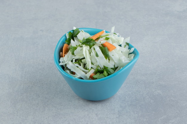 Delectable sliced vegetables in a bowl , on the marble background.