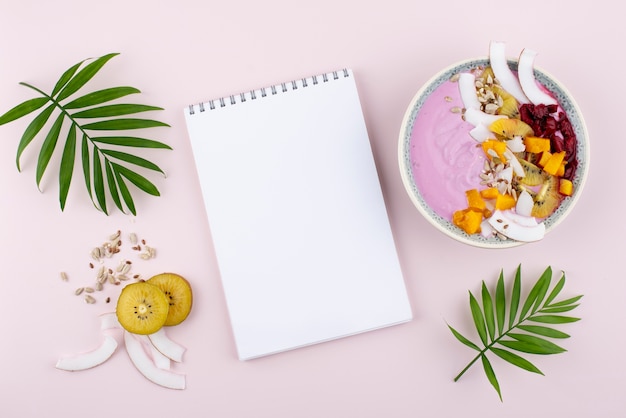 Free photo delicious açai bowl arrangement with empty notepad