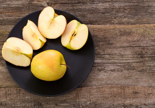 delicious apple on a plate over a wooden table