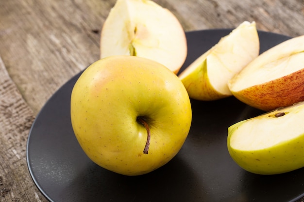 delicious apple on a plate over a wooden table