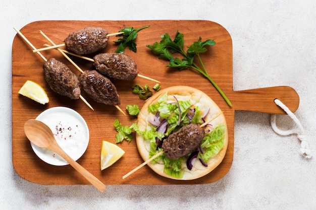 Free Photo delicious arabic fast-food skewers on wooden board