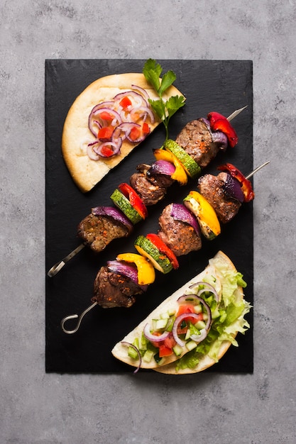 Free photo delicious arabic fast-food top view ingredients on skewers