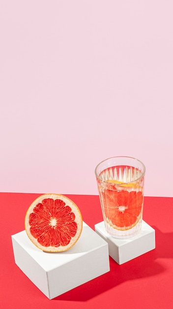 Free Photo delicious blood orange half in glass high angle