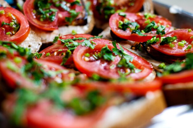 Delicious breakfast sliced yummy toasts with fresh vegetables and greens on silver pan