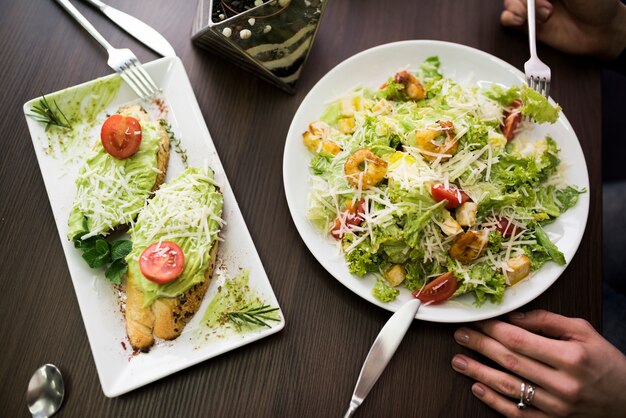 Delicious breakfast on table in front of a person