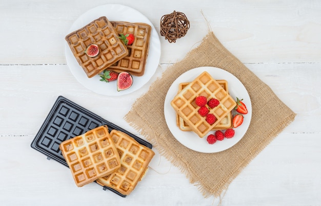 Delicious breakfast with waffles and fruits