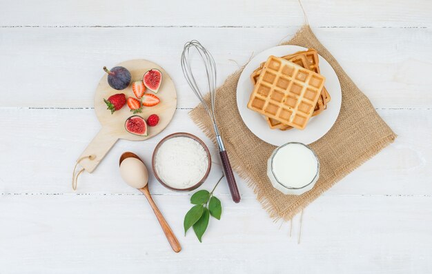 Delicious breakfast with waffles and fruits