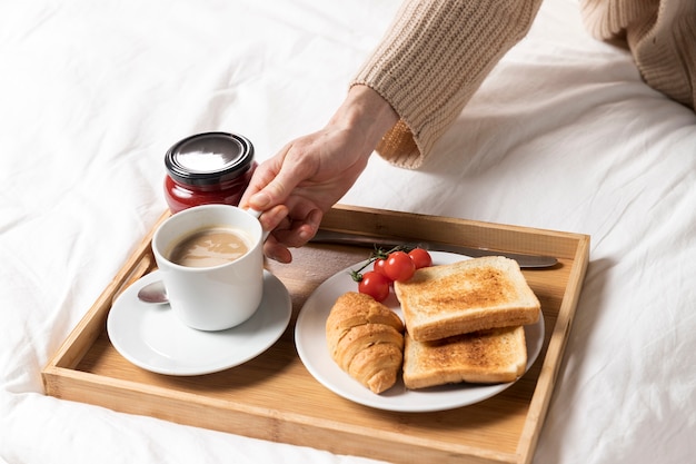 Delicious brunch on bed for pregnant woman