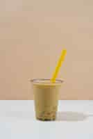 Free photo delicious bubble tea drink with milk and yellow straw