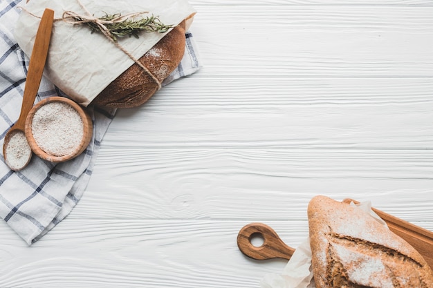 Delicious buns of bread on wooden table