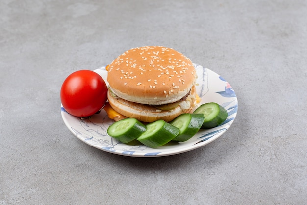 Free photo delicious burger with vegetables on colorful plate