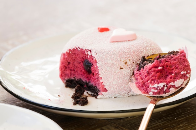 Delicious cake on plate with spoon