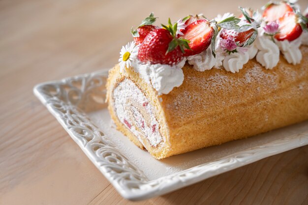 Delicious cake and strawberries high angle