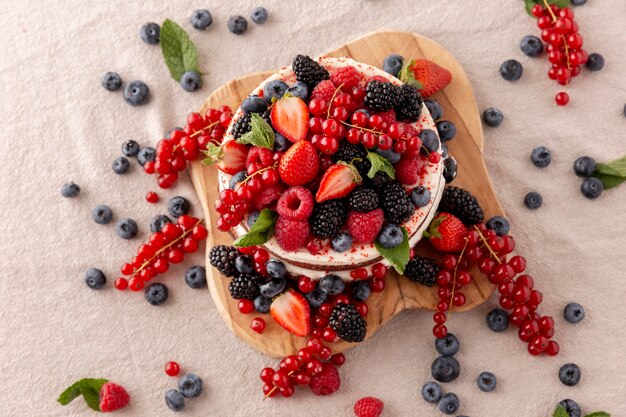 Delicious cake with forest fruits composition