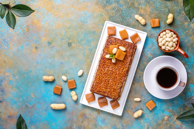 Delicious caramel and peanut cake with peanuts and caramel candies, top view