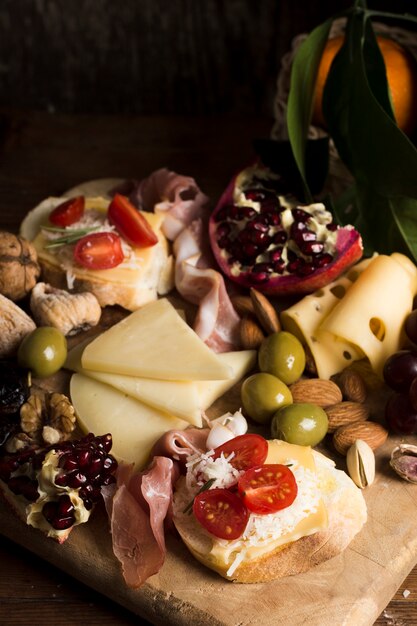 Delicious cheese with tomatoes composition on table