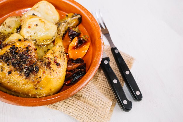 Delicious chicken leg in bowl