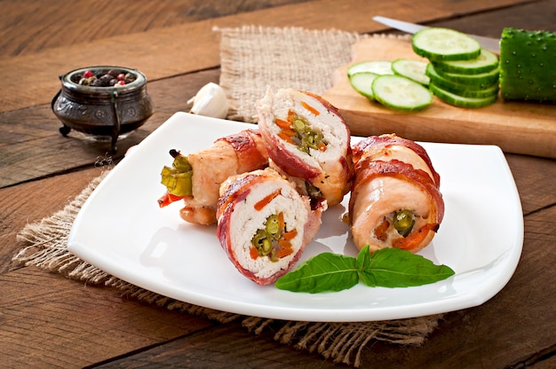 Free Photo delicious chicken rolls stuffed with green beans and carrots wrapped in strips of bacon