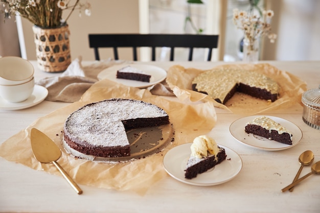 Free photo delicious chocolate cake with cream on a white table presented with aesthetic details