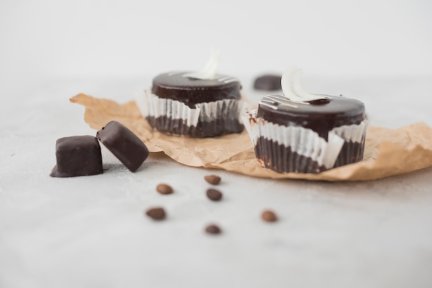 Delicious chocolate cupcake on concrete textured backdrop