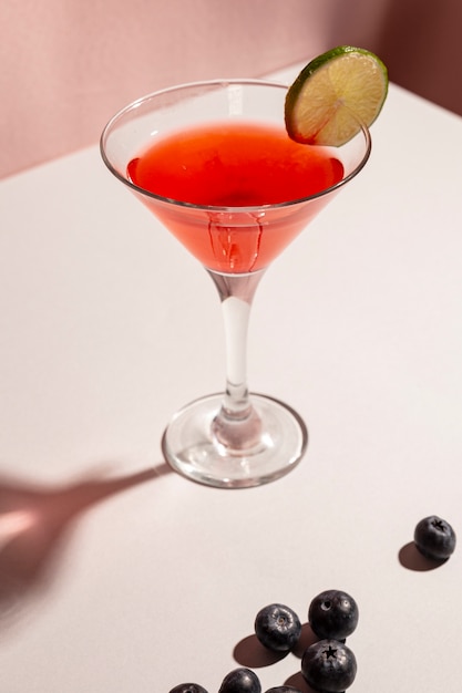 Delicious cocktail with blue berries over white desk