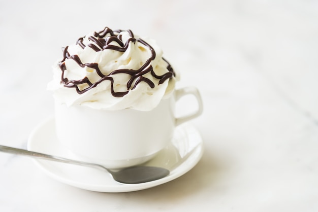 Delicious coffee with whipped cream and chocolate syrup