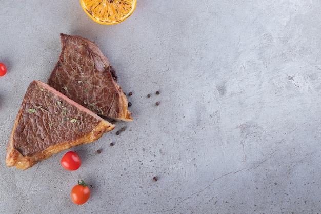 Delicious cooked meat placed on a stone background.