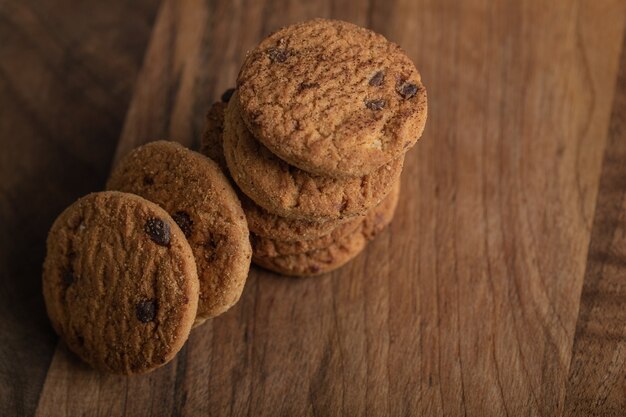 Delicious cookies with chocolate on a wooden board. 