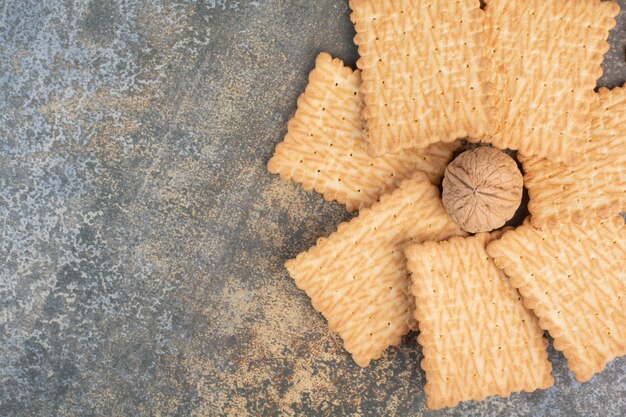 Delicious cookies with walnut on marble background. High quality photo