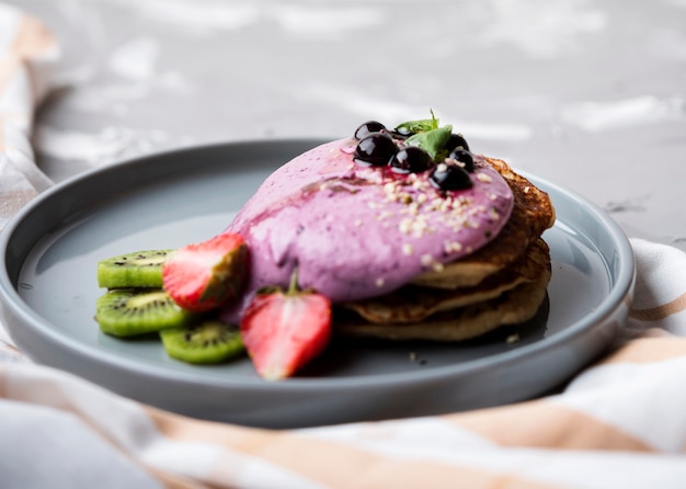 Delicious crepes with halves of strawberry and kiwi