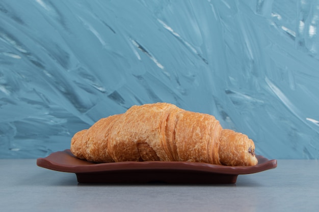 Delicious croissant on plate , on the marble background. High quality photo