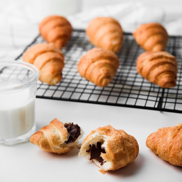 Delicious croissants with milk on the table