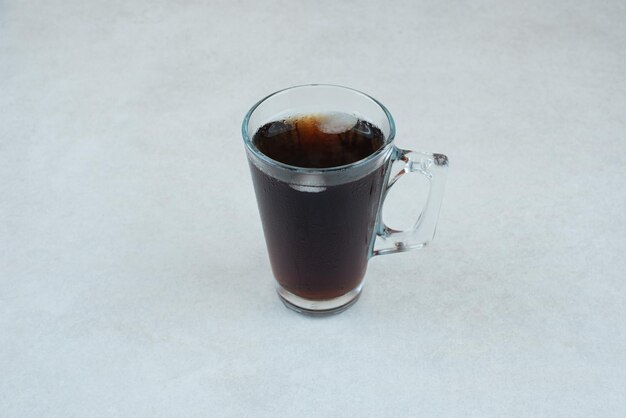 Delicious cup of tea on white table.