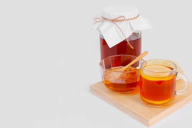 Delicious cup of tea with lemon on a wooden board