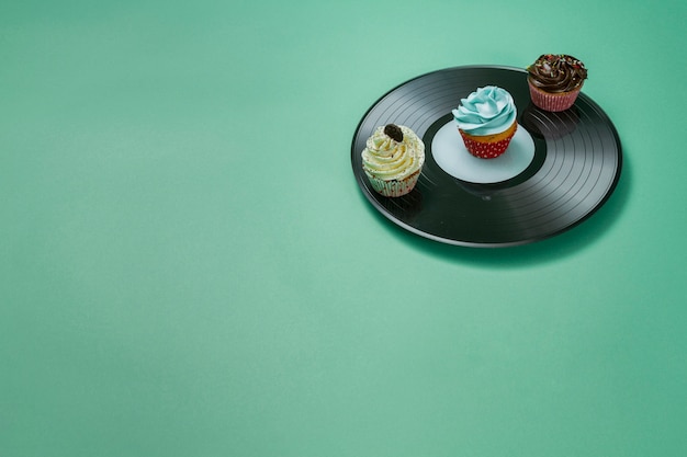 Free Photo delicious cupcakes on vinyl