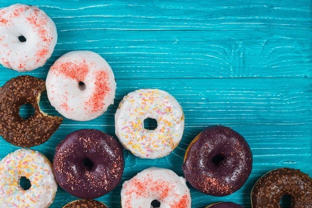 Delicious different chocolate bitten doughnuts topping colorful sprinkles