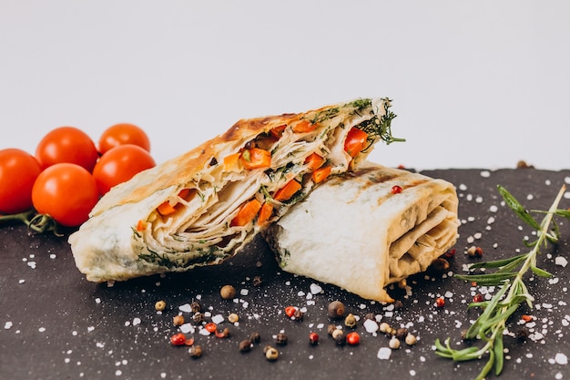 Free photo delicious fajita with chicken isolated on black board