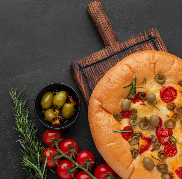 Delicious foccacia and ingredients top view