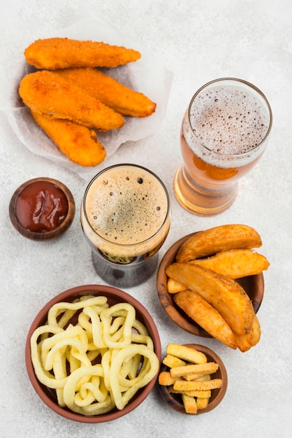 Free photo delicious food and beer glasses flat lay