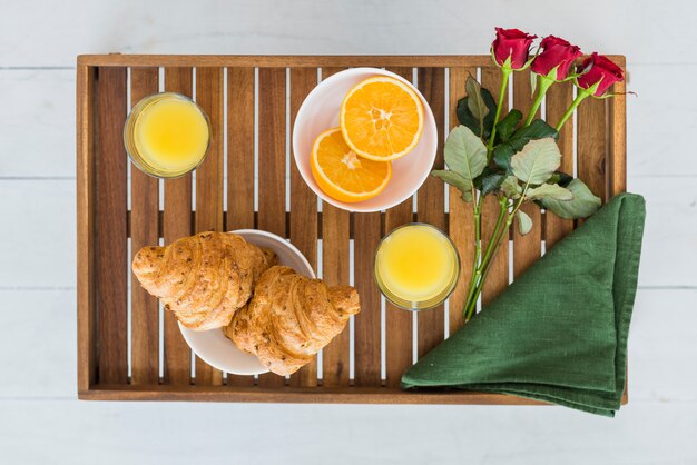 Delicious food and flowers on breakfast table