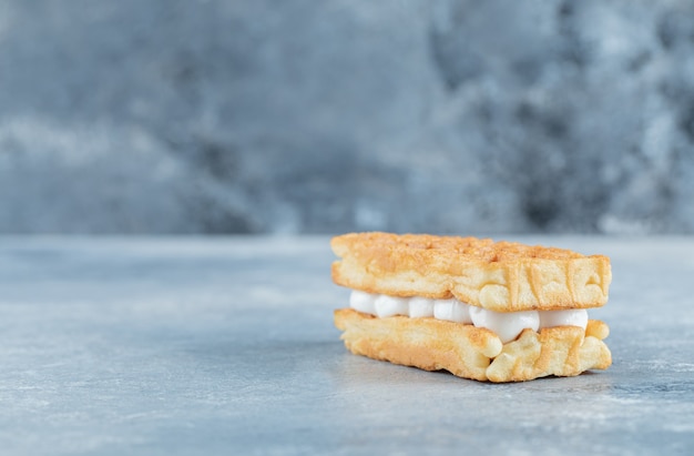 Delicious fresh waffle on a gray background.